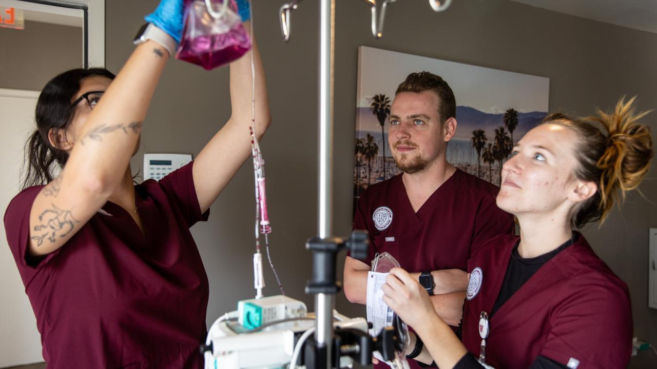 westmont nursing students hanging fluid bag