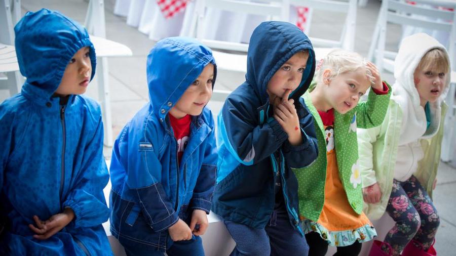 Kids in raincoats at Family Day.